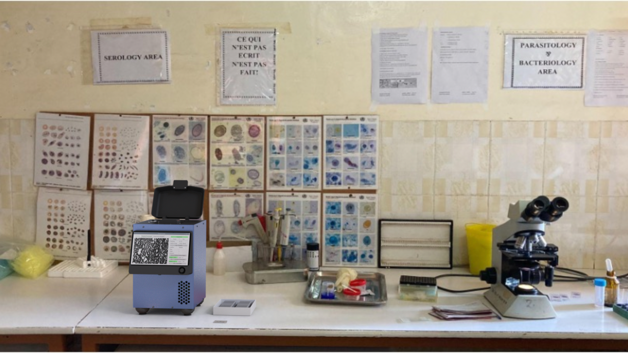 A Remoscope on a clinical lab bench beside a traditional microscope, parasitology and serology reference charts on the wall behind